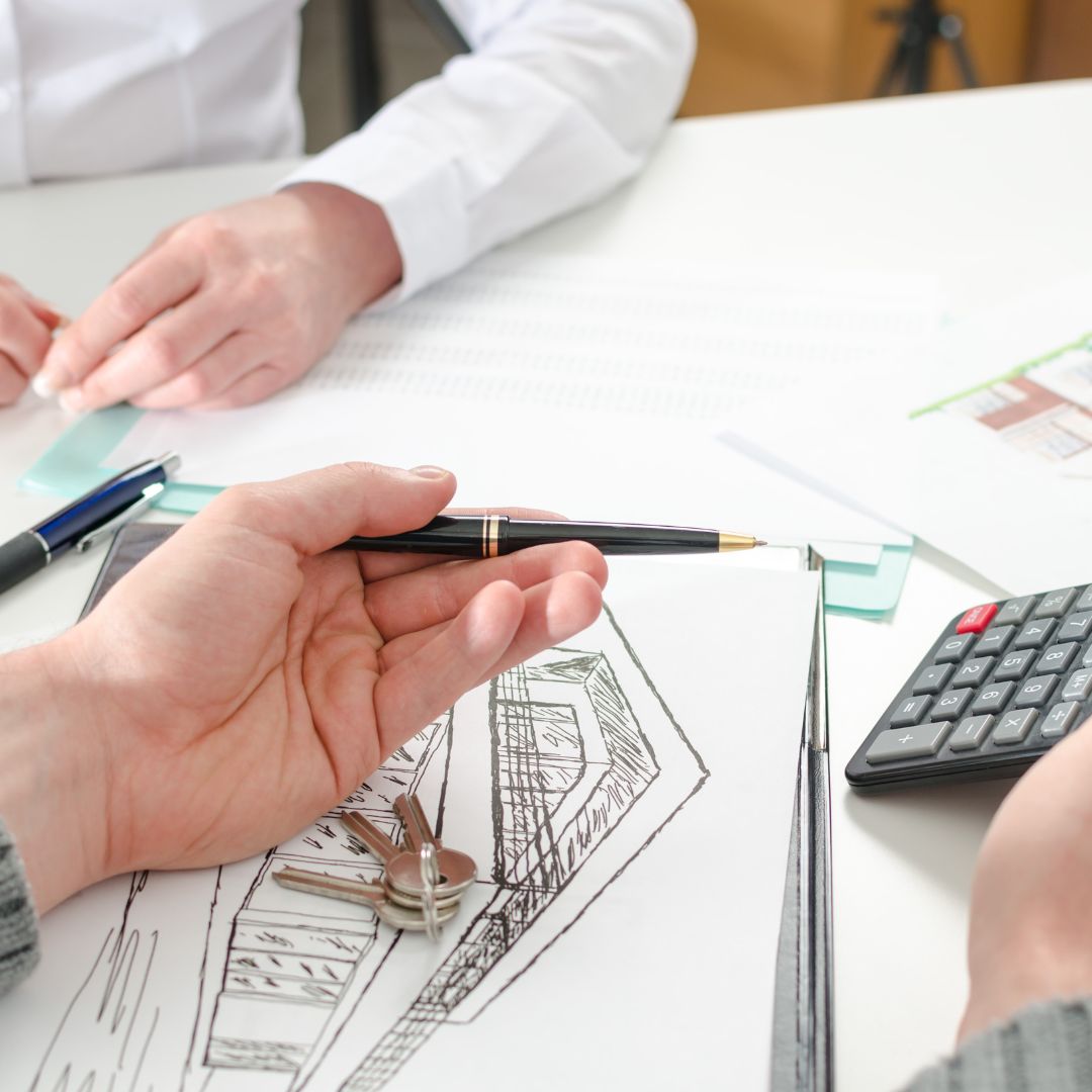 real estate agent pointing at calculator
