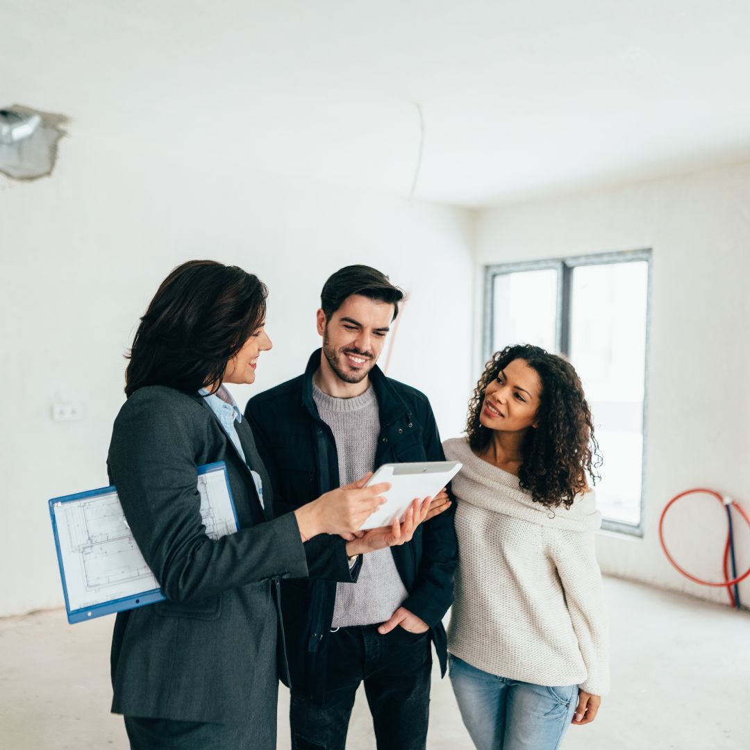 Real estate agent and couple touring home
