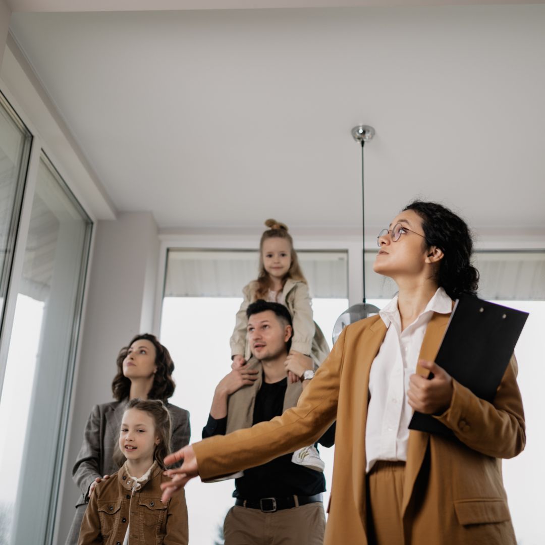 Real estate agent showing family around home