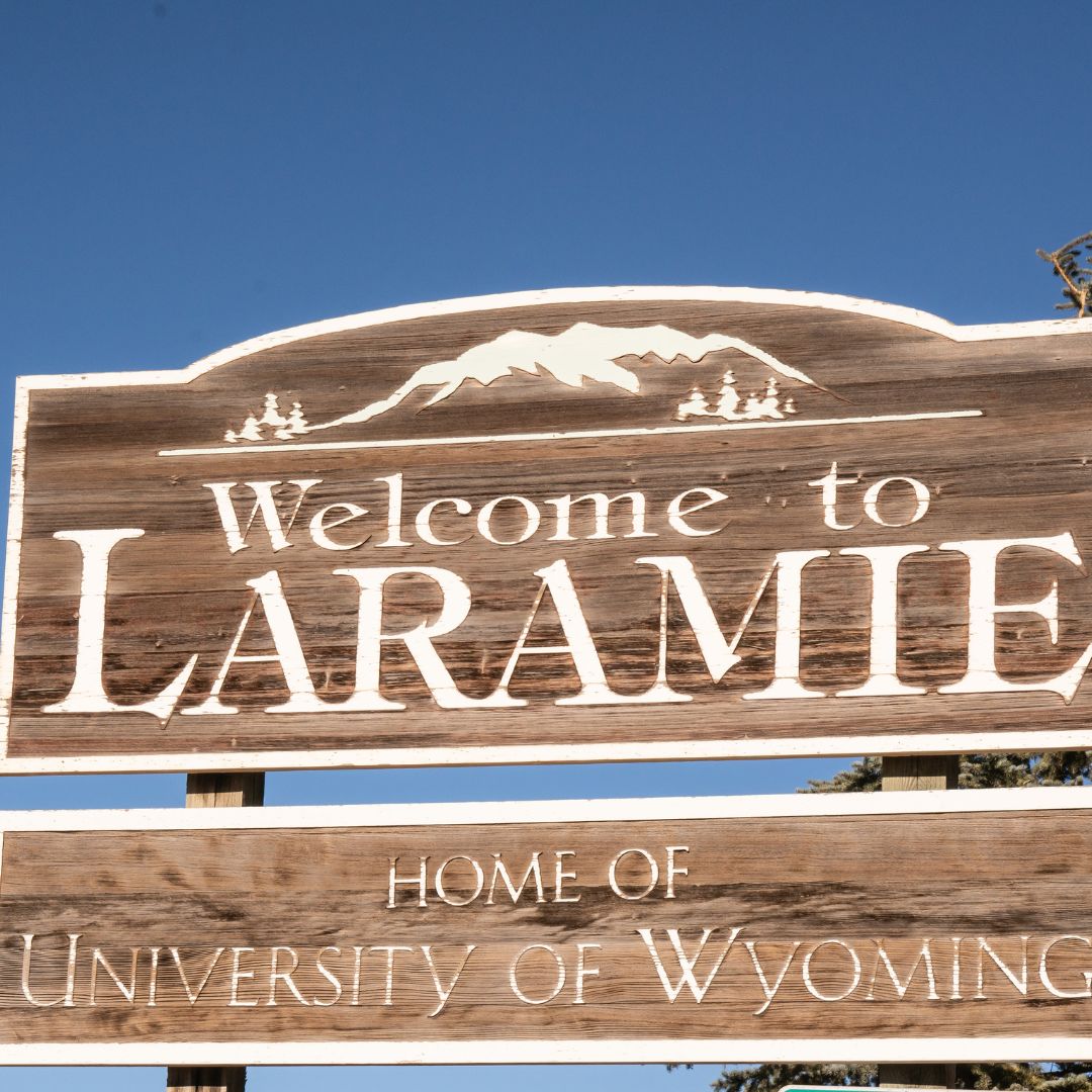 picture of a sign that says welcome to laramie, home of university of wyoming