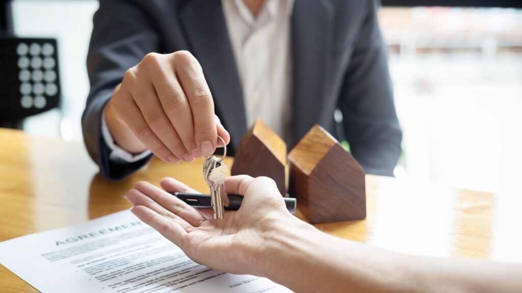 realtor giving keys to new homeowner