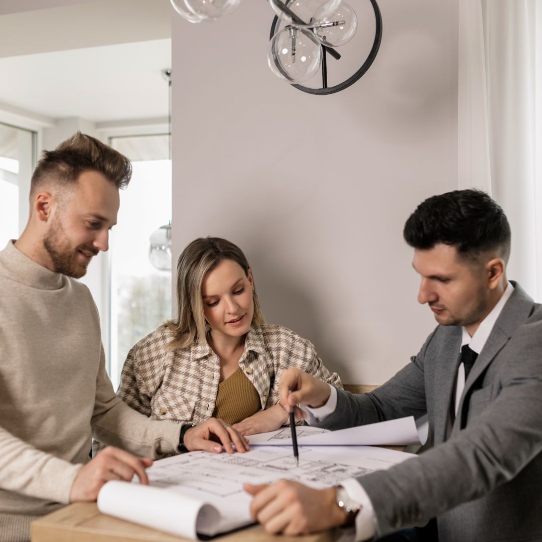 Couple with a real estate agent discussing options